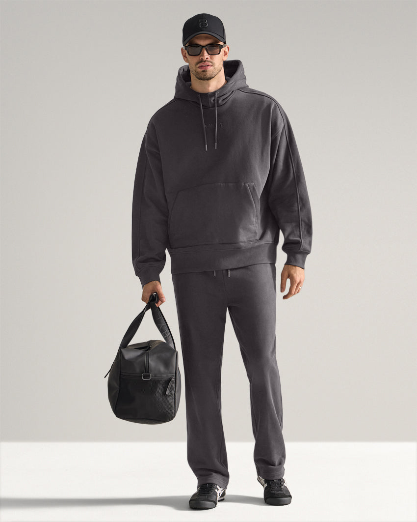 Dark-Charcoal | Full-length view of the Heavyweight Fleece Hoodie worn with matching pants, cap, sunglasses and duffel bag